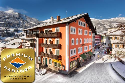 a building with a sign in front of a street at Aurora Appartements inklusive freiem Thermeneintritt in Bad Hofgastein