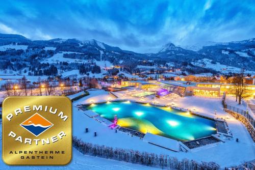 a view of a resort in the snow at night at Aurora Appartements inklusive freiem Thermeneintritt in Bad Hofgastein