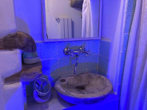 a blue bathroom with a sink and a toilet at MY HOME SCARPERIA in Scarperia
