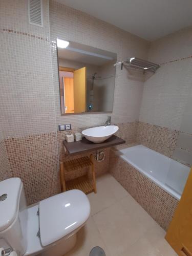 a bathroom with a sink and a toilet and a tub at Taina La Envia Golf in La Envia