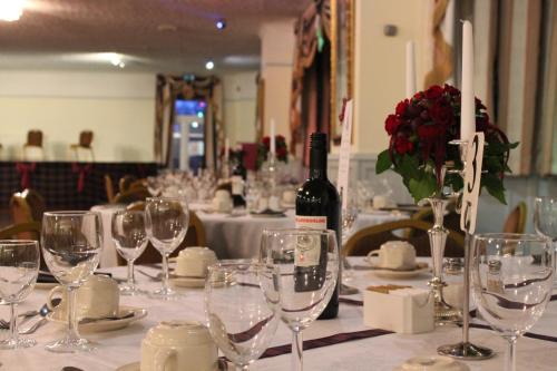 a table with glasses and a bottle of wine at The Paddocks Hotel in Symonds Yat