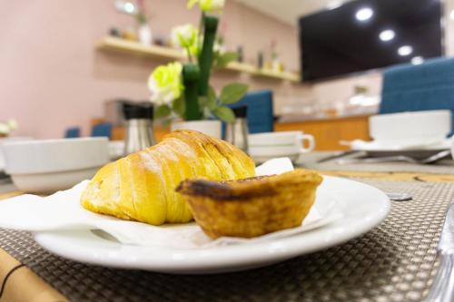 a white plate with a loaf of bread on a table at Residencial do Areeiro in Lisbon