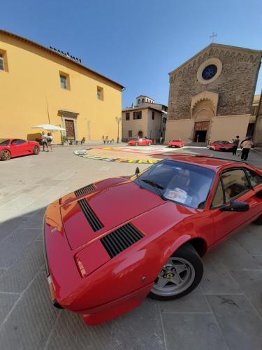 a red car parked in front of a building at MY HOME SCARPERIA in Scarperia