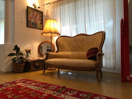 a living room with a chair and a lamp at Conacul Paloși in Horezu