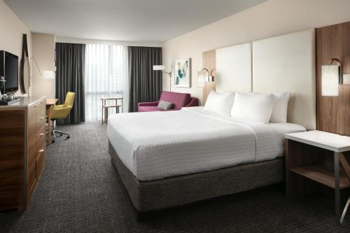 a hotel room with a large bed and a tv at Crowne Plaza Houston Med Ctr-Galleria Area by IHG in Houston