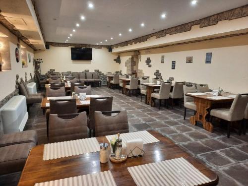 a restaurant with tables and chairs in a room at Optima Kropivnytskiy Hotel in Kropyvnytskyi