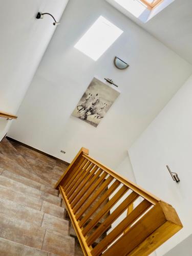 a room with a staircase and a painting on the wall at Gold Horse Vendégház in Szilvásvárad