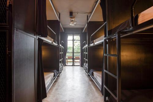 a hallway with bunk beds in a train at Box Hostel N Cafe in Chiang Mai