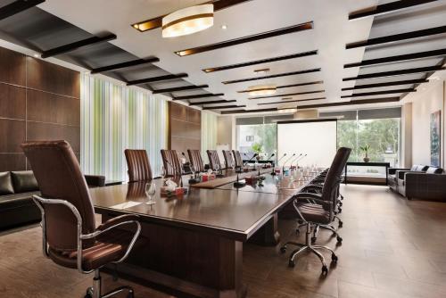 a large conference room with a long table and chairs at Ramada Plaza by Wyndham Karachi Airport Hotel in Karachi