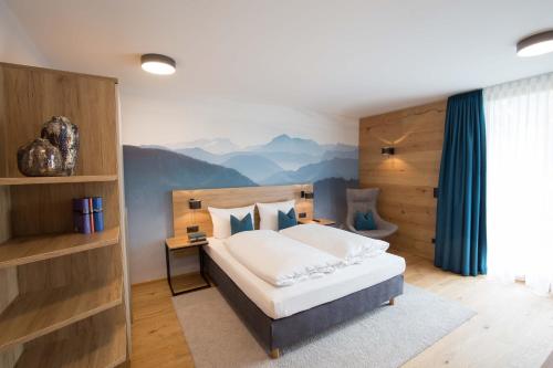 a bedroom with a bed with a mountain mural on the wall at Leo Apartments Miesbach in Miesbach