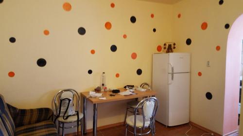 a kitchen with a table and a refrigerator at Apartament cu 2 camere spatioase in centrul orasului - ANDREI in Brăila
