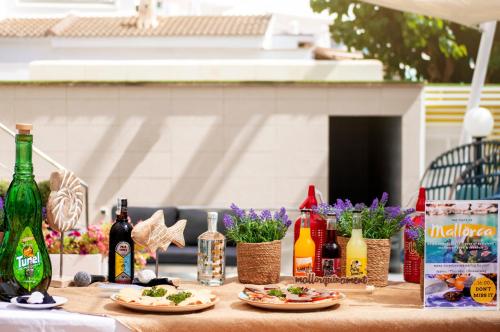 a table with plates of food and bottles of wine at Bordoy Cosmopolitan in Playa de Palma