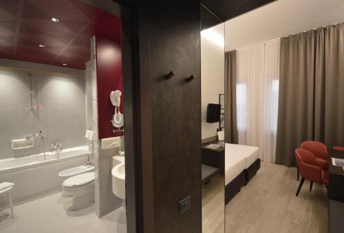 a bathroom with a toilet and a sink at Hotel Friuli in Udine