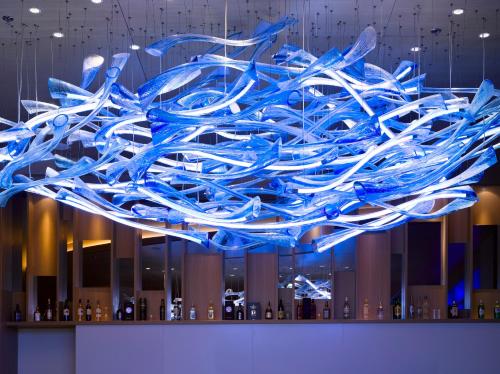 a large blue glass sculpture hanging from a ceiling at Wyndham Grand Istanbul Europe in Istanbul