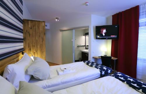 a hotel room with a bed and a tv at Kompassen in Enköping