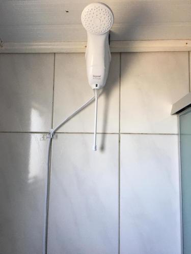 a white hair dryer on the corner of a wall at Pousada Cristal Serra in Cambará