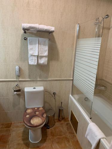 a bathroom with a toilet with a wooden bowl on the seat at Katarino Mountain House in Razlog