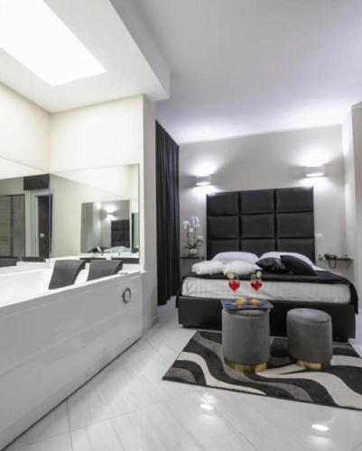 a bedroom with a large bed and a bath tub at Hotel Trionfal in Qualiano