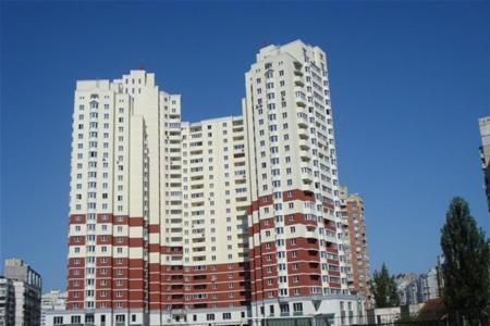 two tall white buildings in a city at Osokorky Apartments in Kyiv