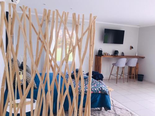 a bedroom with a bed with wooden sticks on it at Chambre d'hôtes Ama in Pompignac