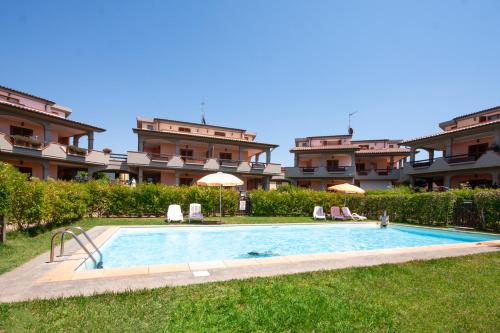 a swimming pool in front of a building at Follonica Apartments - Pool & Relax in Follonica