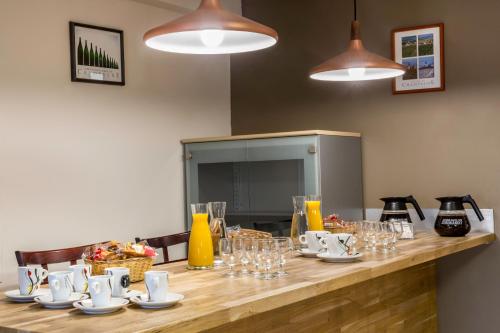 a long wooden table with glasses and plates on it at Sure Hotel by Best Western Reims Nord in Reims