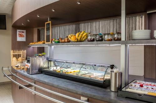a buffet line in a restaurant with a bunch of food at Sure Hotel by Best Western Reims Nord in Reims