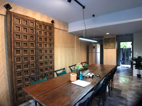 a dining room with a wooden table and chairs at 8th House @ center of Chiangmai old town in Chiang Mai