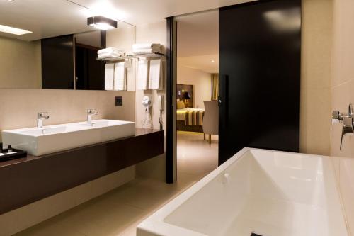 a bathroom with a sink and a large mirror at Ritz Leblon in Rio de Janeiro