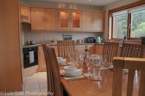 a kitchen with a wooden table with glasses on it at 22 Drumcoura Lake Resort Holid in Ballinamore
