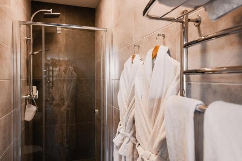 a bathroom with white towels hanging on a rack at Sofia Hotel in Rivne