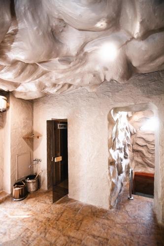 a room with a stone wall and a room with a door at Sofia Hotel in Rivne