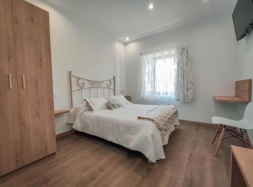 Postel nebo postele na pokoji v ubytování Hostal Óleo Auto Check-in