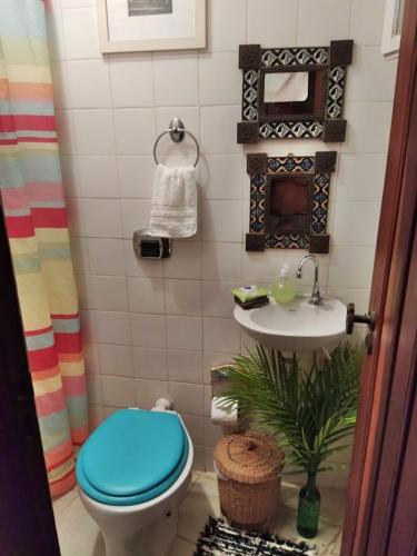 a bathroom with a toilet and a sink at Casa Vista Para o Mar in Ilhabela