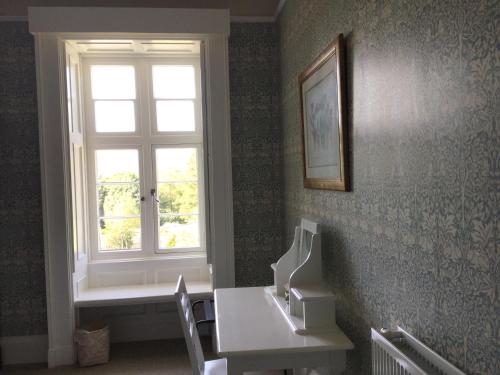 a room with a window and a table and a window seat at The Lake Lodge, Wansfell Holme, Windermere in Ambleside