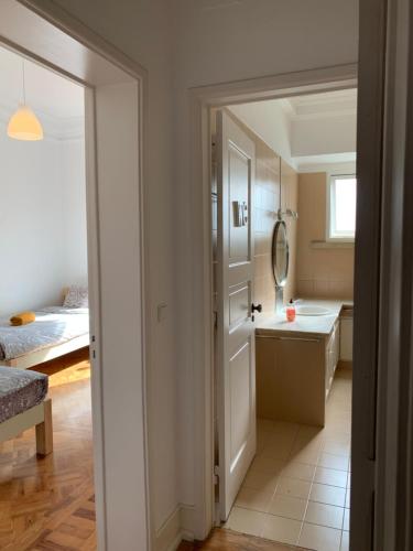 a small bathroom with a sink and a mirror at Rose view guest house in Lisbon
