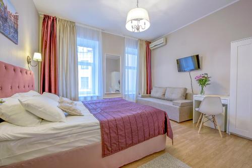 a hotel room with a bed and a chair at Nevsky Row Hotel - Nevsky 100 in Saint Petersburg