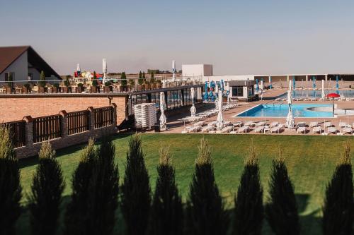 a resort with a swimming pool and chairs and a resort at Sofia Hotel in Rivne