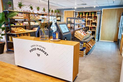 a counter in a store with a food market at Amrâth Apart-Hotel Schiphol Badhoevedorp in Badhoevedorp