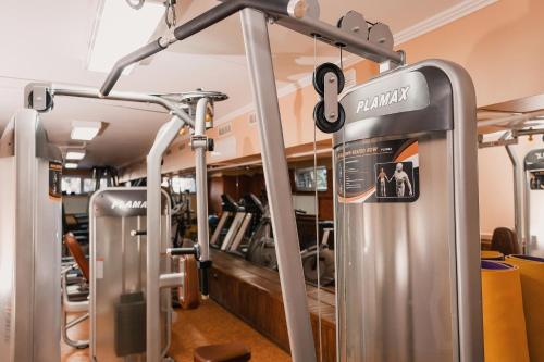 a gym with several treadmills and machines at Sofia Hotel in Rivne
