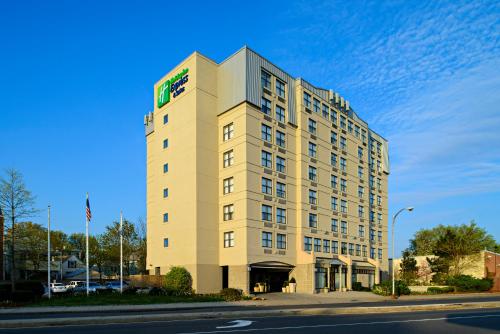a tall building with a sign on top of it at Holiday Inn Express & Suites Boston - Cambridge by IHG in Cambridge