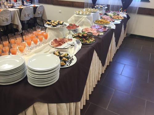 a long table with plates of food on it at Hotel Fiera Rho in Rho