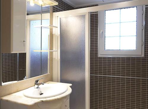 a bathroom with a sink and a window and a mirror at Villa Miguel - Plusholidays in Benissa