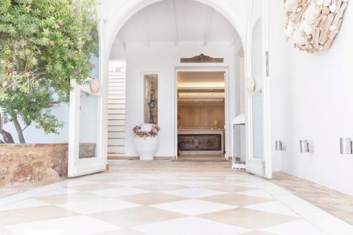 an entryway with a checkered floor at Stelia Mare Boutique Hotel in Naousa