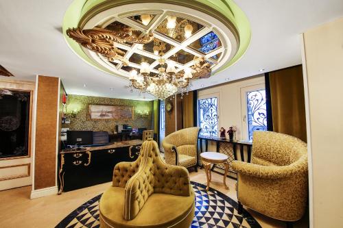 a living room with chairs and a chandelier at Katelya Hotel in Istanbul