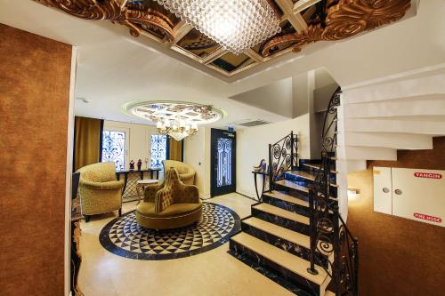 a living room with a staircase and a chandelier at Katelya Hotel in Istanbul