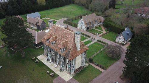 an aerial view of a large house with a roof at Les Manoirs des Portes de Deauville - Small Luxury Hotel Of The World in Deauville