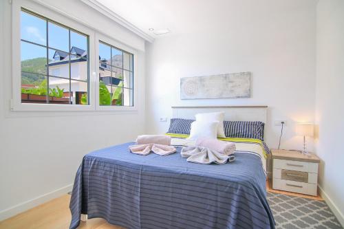 a bedroom with a bed with two towels on it at Villa con piscina privada - Polop in Polop