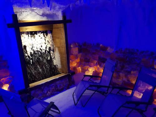 a room with a fireplace and chairs in it at Ruhr Inn Hotel in Hattingen