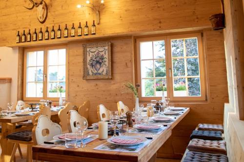 a dining room with a long table and chairs at Alpenlodge Val Gronda in Obersaxen